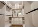 Walk-in closet with custom shelving, drawers, and hanging rods for ample storage at 219 Poplar Nw St, Lilburn, GA 30047