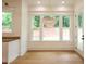 Dining area with chandelier, three windows, hardwood floor and backyard view at 219 Poplar Nw St, Lilburn, GA 30047