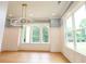 Sunlit dining room showcasing a large window, decorative molding, and hardwood flooring at 219 Poplar Nw St, Lilburn, GA 30047