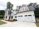 A lovely home with a prominent three-car garage and a beautiful light-colored exterior at 219 Poplar Nw St, Lilburn, GA 30047