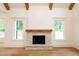 Living room fireplace with wooden mantel and built-in shelving at 219 Poplar Nw St, Lilburn, GA 30047