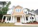 A charming home featuring a light-colored exterior, wood accents, and a welcoming front porch at 219 Poplar Nw St, Lilburn, GA 30047