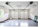 Spacious two-car garage featuring epoxy flooring, white walls, and ample lighting, a functional space at 219 Poplar Nw St, Lilburn, GA 30047