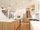 Modern kitchen with a large island, stainless steel appliances, and sleek white countertops at 219 Poplar Nw St, Lilburn, GA 30047