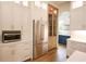 Stylish kitchen featuring white cabinetry, stainless steel appliances, and natural wood accents at 219 Poplar Nw St, Lilburn, GA 30047