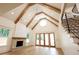 Bright living room features vaulted ceiling, wooden beams, stone fireplace, and hardwood floors at 219 Poplar Nw St, Lilburn, GA 30047