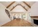 Open concept living area flows into kitchen with exposed-beam ceiling at 219 Poplar Nw St, Lilburn, GA 30047