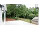 Outdoor patio with horizontal iron railing offers stunning views of lush backyard and surrounding greenery at 219 Poplar Nw St, Lilburn, GA 30047