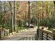 Picturesque wooden walking bridge meanders through a serene forest landscape, perfect for nature lovers at 219 Poplar Nw St, Lilburn, GA 30047