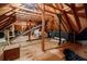 Unfinished attic space with exposed wooden beams and a plywood floor at 3030 Spalding Dr, Sandy Springs, GA 30350