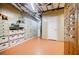 Finished basement featuring wood-paneled walls, storage cabinets, and open shelving for ample organization at 3030 Spalding Dr, Sandy Springs, GA 30350