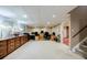 Finished basement office space with neutral carpet, recessed lighting, and ample built-ins at 3030 Spalding Dr, Sandy Springs, GA 30350