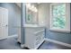 Bathroom featuring double vanity with tile flooring, a large mirror, and a window at 3030 Spalding Dr, Sandy Springs, GA 30350