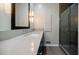 Modern bathroom with a long vanity, large mirror and glass shower door at 3030 Spalding Dr, Sandy Springs, GA 30350