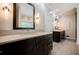 Modern bathroom featuring dual vanities, neutral colored tile flooring, modern lighting and fixtures at 3030 Spalding Dr, Sandy Springs, GA 30350
