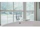 Close up of a free-standing bathtub faucet with a large bright window with blinds at 3030 Spalding Dr, Sandy Springs, GA 30350