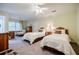 Bright bedroom featuring twin beds, a ceiling fan and neutral decor at 3030 Spalding Dr, Sandy Springs, GA 30350