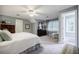 Spacious bedroom with neutral carpet, large windows, and adjacent seating area at 3030 Spalding Dr, Sandy Springs, GA 30350