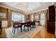 Formal dining room with hardwood floors, large windows, a chandelier, and decorative drapes at 3030 Spalding Dr, Sandy Springs, GA 30350