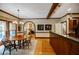 Elegant dining room featuring wood floors, a wood beam ceiling, an arched doorway, and a view into the living room at 3030 Spalding Dr, Sandy Springs, GA 30350