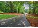 Long driveway leading to a beautiful home surrounded by nature at 3030 Spalding Dr, Sandy Springs, GA 30350