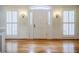 Elegant foyer with hardwood floors, white door and trim, and sidelight windows at 3030 Spalding Dr, Sandy Springs, GA 30350