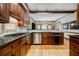 Gourmet kitchen with wood cabinets, stainless steel appliances, granite countertops, and hardwood floors at 3030 Spalding Dr, Sandy Springs, GA 30350