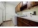 Functional laundry room with cabinetry, sink, washer, dryer, and hanging rack at 3030 Spalding Dr, Sandy Springs, GA 30350