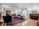 Spacious living room with built-in shelves, hardwood floors, fireplace, and ample natural light at 3030 Spalding Dr, Sandy Springs, GA 30350