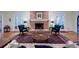 Traditional living room featuring a brick fireplace, large area rug, and classic furniture at 3030 Spalding Dr, Sandy Springs, GA 30350