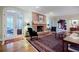 Cozy living room with a brick fireplace, hardwood floors, and French doors leading to outdoor patio at 3030 Spalding Dr, Sandy Springs, GA 30350