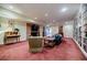 Spacious living room features a brick fireplace, built-in bookshelves, and plush carpeting at 3030 Spalding Dr, Sandy Springs, GA 30350