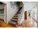 Grand foyer with wooden staircase and hardwood floors leading to an upper level at 3030 Spalding Dr, Sandy Springs, GA 30350
