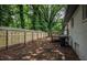Fenced backyard with deck and mature trees at 5640 Redan Cir, Stone Mountain, GA 30088
