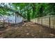 Large, fenced backyard with mature trees and space for recreation at 5640 Redan Cir, Stone Mountain, GA 30088