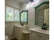 Bathroom with double sinks, decorative mirrors, and window at 5640 Redan Cir, Stone Mountain, GA 30088