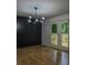 Modern dining area featuring an elegant chandelier and patio access, adjacent to stylish living room with wood floors at 5640 Redan Cir, Stone Mountain, GA 30088