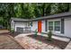 Inviting brick-paved walkway leads to a charming front porch and the bright orange front door of the freshly painted home at 5640 Redan Cir, Stone Mountain, GA 30088