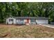 Charming, newly renovated single-story home featuring a bright orange front door and modern exterior paint at 5640 Redan Cir, Stone Mountain, GA 30088