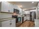 Well-lit kitchen with stainless steel appliances, subway tile, and granite countertops at 5640 Redan Cir, Stone Mountain, GA 30088