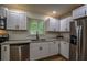 Kitchen with stainless appliances, granite countertops, white cabinets and undermount sink at 5640 Redan Cir, Stone Mountain, GA 30088