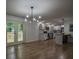 Open concept kitchen and dining area with white cabinets, hardwood floors and access to deck at 5640 Redan Cir, Stone Mountain, GA 30088