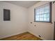Laundry room featuring wood-look floors and a window for natural light at 5640 Redan Cir, Stone Mountain, GA 30088