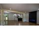 Open-concept living space featuring wood floors and modern fireplace, seamlessly connecting to the kitchen and dining area at 5640 Redan Cir, Stone Mountain, GA 30088