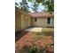 Simple backyard of a tan home with a concrete patio and exterior doors at 6103 Chaseland Dr, Rex, GA 30273