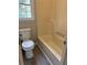 Bathroom with a standard bathtub with shower and window at 6103 Chaseland Dr, Rex, GA 30273