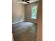 Bedroom featuring wood-look floors, a ceiling fan and natural light from the window at 6103 Chaseland Dr, Rex, GA 30273