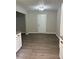 Open kitchen area features modern wood-look flooring and sleek, white cabinetry for a bright, contemporary feel at 6103 Chaseland Dr, Rex, GA 30273