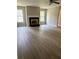 Spacious living room featuring a fireplace, neutral paint, new flooring and bright windows at 6103 Chaseland Dr, Rex, GA 30273