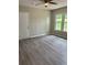 Inviting living room with modern flooring, bright windows, and a ceiling fan offers a comfortable living space at 6103 Chaseland Dr, Rex, GA 30273